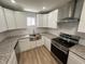 This kitchen features shaker cabinets, granite countertops, stainless appliances, and a stainless farmhouse sink at 905 Ardmore Dr, Durham, NC 27713