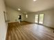 The living room features wood-look floors, neutral paint, and an exterior door with access to an outdoor deck at 905 Ardmore Dr, Durham, NC 27713