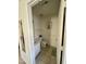 A half bathroom with a sink, toilet, and beige tile floor provides essential convenience at 1140 Carlton Ave # 201, Raleigh, NC 27606