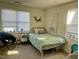 Cozy bedroom with a full-sized bed, natural light from two windows, and minimalist decor at 1140 Carlton Ave # 201, Raleigh, NC 27606