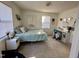 Sunny bedroom with a bed, desk, and two windows providing natural light creating a cozy and inviting space at 1140 Carlton Ave # 201, Raleigh, NC 27606