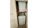 A compact laundry closet with a stacked washer and dryer maximizes space and functionality at 1140 Carlton Ave # 201, Raleigh, NC 27606