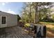 View of the back deck and yard with a grill, storage, and mature trees at 1203 Brookside Dr, Raleigh, NC 27604