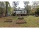 Backyard view of the house with a deck, ladder, and a garden at 1203 Brookside Dr, Raleigh, NC 27604