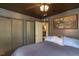 Bedroom featuring a ceiling fan, two closets, a window, and artwork displayed on the walls at 1203 Brookside Dr, Raleigh, NC 27604