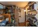 View of bedroom with shelving, boxes, and bed. Doorway leads to another room at 1203 Brookside Dr, Raleigh, NC 27604
