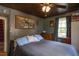 Spacious bedroom featuring a ceiling fan, wood floors, one window, and artwork displayed on the walls at 1203 Brookside Dr, Raleigh, NC 27604