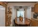 Cozy dining area featuring a wooden table with chairs, surrounded by cabinets and a window with curtains at 1203 Brookside Dr, Raleigh, NC 27604