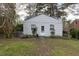 Quaint single-story home with light siding, complemented by a mailbox and surrounded by mature trees at 1203 Brookside Dr, Raleigh, NC 27604