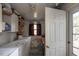 Utility room featuring a washer, dryer, window, and storage shelves next to the back door at 1203 Brookside Dr, Raleigh, NC 27604