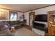 Cozy living room featuring a brown sofa, and an open doorway leading to an adjacent room at 1203 Brookside Dr, Raleigh, NC 27604