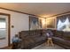 Comfortable living room featuring a sectional sofa, patterned rug, and bright natural light from the windows at 1203 Brookside Dr, Raleigh, NC 27604