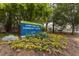Lions Park and Community Center sign with colorful flowers in front of it and a treelined park in the background at 1203 Brookside Dr, Raleigh, NC 27604
