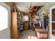 A crammed storage room with various items, revealing an open ceiling and wood-paneled walls at 1203 Brookside Dr, Raleigh, NC 27604