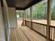 Outdoor living area with wood porch and view of wooded backyard at 124 Horseman Dr, Louisburg, NC 27549