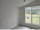 Bright bedroom featuring a large window overlooking a well maintained yard with a fence at 124 Horseman Dr, Louisburg, NC 27549