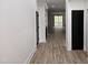 Inviting entryway with wood floors, white walls, and black doors leading into other rooms at 124 Horseman Dr, Louisburg, NC 27549