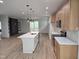 Spacious kitchen featuring an island with a white countertop, wooden cabinets, and a view of the living room at 124 Horseman Dr, Louisburg, NC 27549