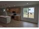 Charming kitchen features an island, wood cabinets, stainless steel appliances, and wood floors at 124 Horseman Dr, Louisburg, NC 27549