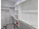 Bright walk-in closet with custom shelving and wood rods at 124 Horseman Dr, Louisburg, NC 27549