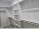 Bright walk-in closet with custom shelving, wood rods and plush carpet flooring at 124 Horseman Dr, Louisburg, NC 27549