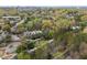 Aerial view showcasing a neighborhood surrounded by lush greenery and urban cityscape in the background at 130 E Longview St # Apt K, Chapel Hill, NC 27516