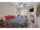 Bedroom with patterned bedding, window seat, ceiling fan, and a mounted TV, blends comfort and functionality at 130 E Longview St # Apt K, Chapel Hill, NC 27516