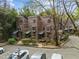 Townhouses with unique wood exterior design, front parking, and surrounding trees at 130 E Longview St # Apt K, Chapel Hill, NC 27516