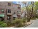 View of exteriors featuring unique wooden facade with round windows and mature trees at 130 E Longview St # Apt K, Chapel Hill, NC 27516