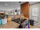 Open-concept kitchen with stainless steel stove, granite counters, and wood cabinets at 130 E Longview St # Apt K, Chapel Hill, NC 27516