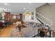 A well-lit living room features a large sectional sofa, fireplace, and access to dining and kitchen areas at 130 E Longview St # Apt K, Chapel Hill, NC 27516