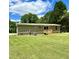 Rear exterior of home with siding, a small porch, and well-maintained green lawn at 1326 Stephens Dr, Roxboro, NC 27573
