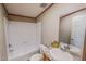 Bright bathroom featuring a shower-tub combo with sleek fixtures and a vanity with a granite countertop at 1326 Stephens Dr, Roxboro, NC 27573