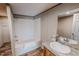 Bright bathroom featuring a shower-tub combo with sleek fixtures and a vanity with a granite countertop at 1326 Stephens Dr, Roxboro, NC 27573