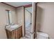 Bright bathroom featuring a vanity with a granite countertop, and a toilet, with doorway to another room at 1326 Stephens Dr, Roxboro, NC 27573
