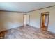 Bedroom with wood-look flooring and doorways to another room and a bathroom at 1326 Stephens Dr, Roxboro, NC 27573