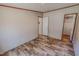 A small bedroom with hardwood floors and an open door to a closet at 1326 Stephens Dr, Roxboro, NC 27573