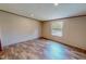 Bedroom with wood-look flooring and a window at 1326 Stephens Dr, Roxboro, NC 27573