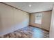An empty bedroom with hardwood floors and a view from the window to the backyard at 1326 Stephens Dr, Roxboro, NC 27573
