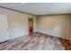 Bedroom featuring wood-look flooring, leading to an ensuite bathroom at 1326 Stephens Dr, Roxboro, NC 27573