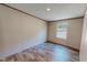 Bedroom with wood-look flooring, a window, and neutral walls at 1326 Stephens Dr, Roxboro, NC 27573