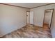Bedroom with wood-look floors, a closet, and a door leading to another room at 1326 Stephens Dr, Roxboro, NC 27573