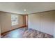 An empty bedroom with hardwood floors and a view from the window to the backyard at 1326 Stephens Dr, Roxboro, NC 27573