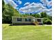 Charming single-story home with beautiful lawn, lush landscaping and a welcoming front porch at 1326 Stephens Dr, Roxboro, NC 27573