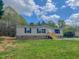 Charming home featuring a brick foundation, complemented by a well-manicured lawn and inviting wooden deck at 1326 Stephens Dr, Roxboro, NC 27573