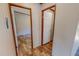 Hallway showing doorways to adjacent rooms with coordinated wood-look flooring at 1326 Stephens Dr, Roxboro, NC 27573