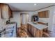 Cozy kitchen featuring wood cabinets, island, stainless steel appliances, and wood laminate flooring at 1326 Stephens Dr, Roxboro, NC 27573