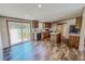 Warm and inviting kitchen with wood cabinets, island, and modern black appliances at 1326 Stephens Dr, Roxboro, NC 27573