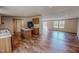 Open-concept kitchen featuring an island with granite counters, wood cabinets, and modern appliances at 1326 Stephens Dr, Roxboro, NC 27573
