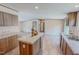 Inviting kitchen island with a sink and wood cabinets with stainless steel appliances creating a stylish space at 1326 Stephens Dr, Roxboro, NC 27573